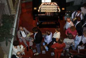 Photo of attendees seeking autographs from Gaylord Carter after his concert