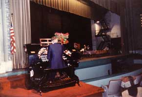 photo of an organist performing during a potluck dinner